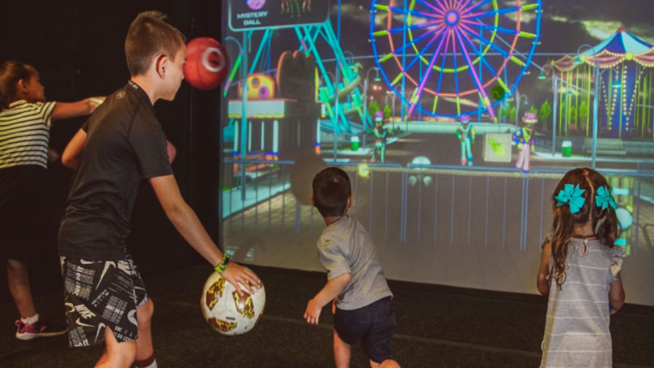 Kids playing the Mystery Ball interactive wall game at a SWING party