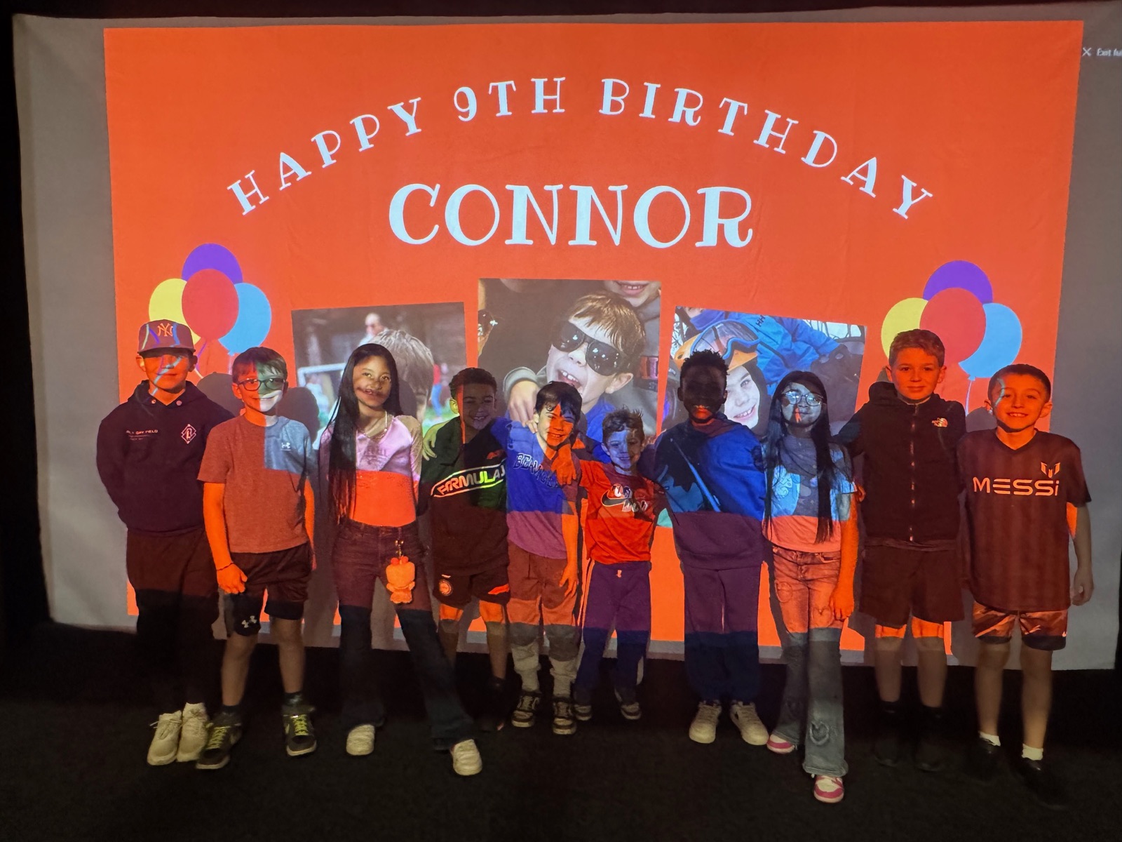 Kids celebrating a birthday party in front of the SWING simulator screen
