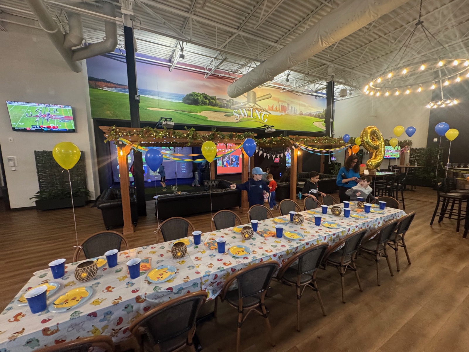 Kids birthday party with families at tables inside SWING Middletown indoor sports venue, Orange County NY